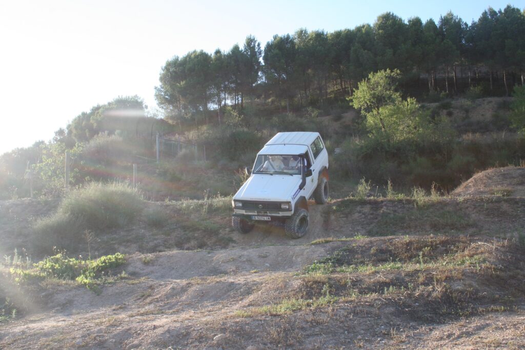 Corporate team navigating rugged terrain in a 4x4 vehicle during a leadership retreat near Barcelona