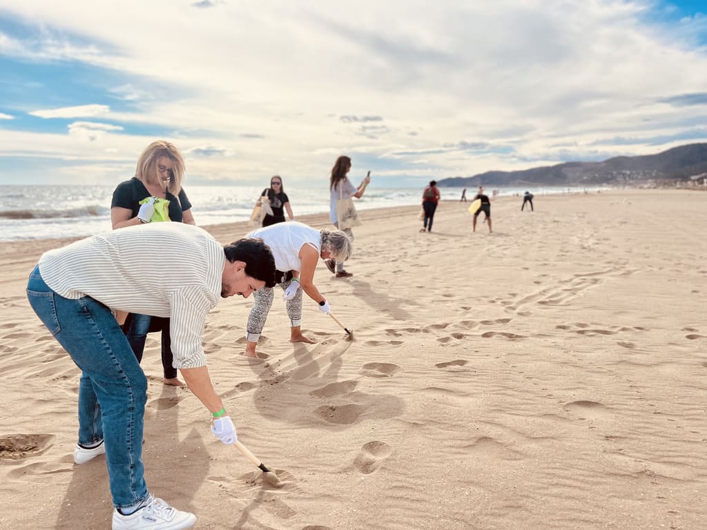 Corporate team beach clean-up CSR activity during a sustainable corporate event in Spain