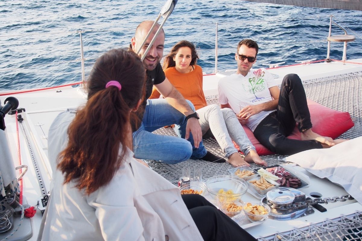 Guests enjoyg a relaxed sailing in a catamaran in Barcelona harbour during an incentive trip