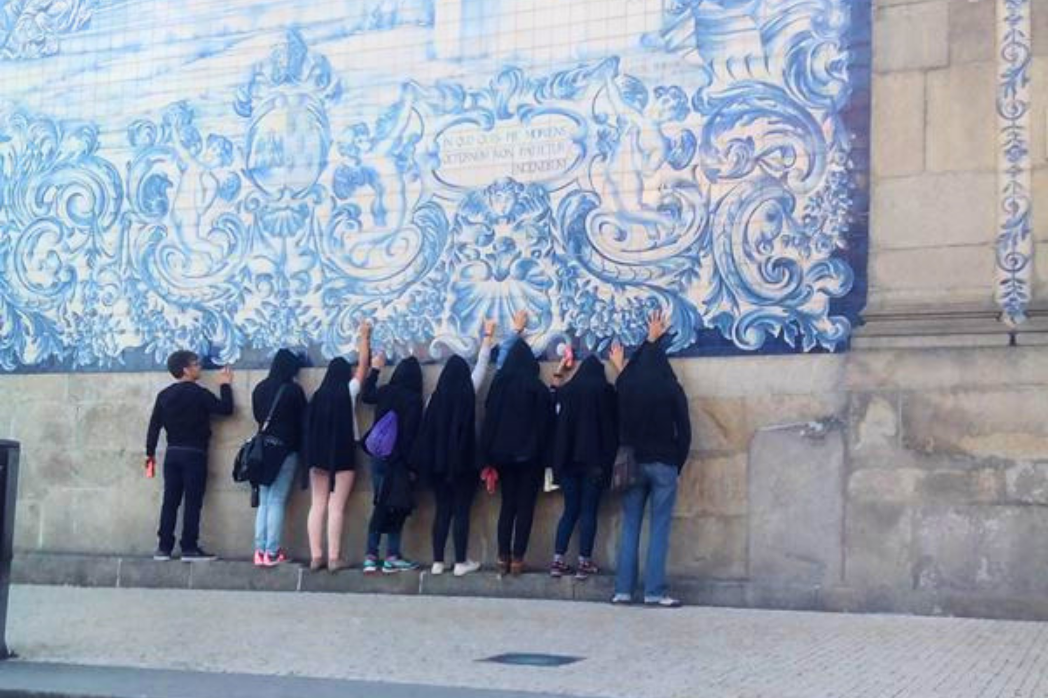 Team using an iPad to solve clues in Porto's historic centre