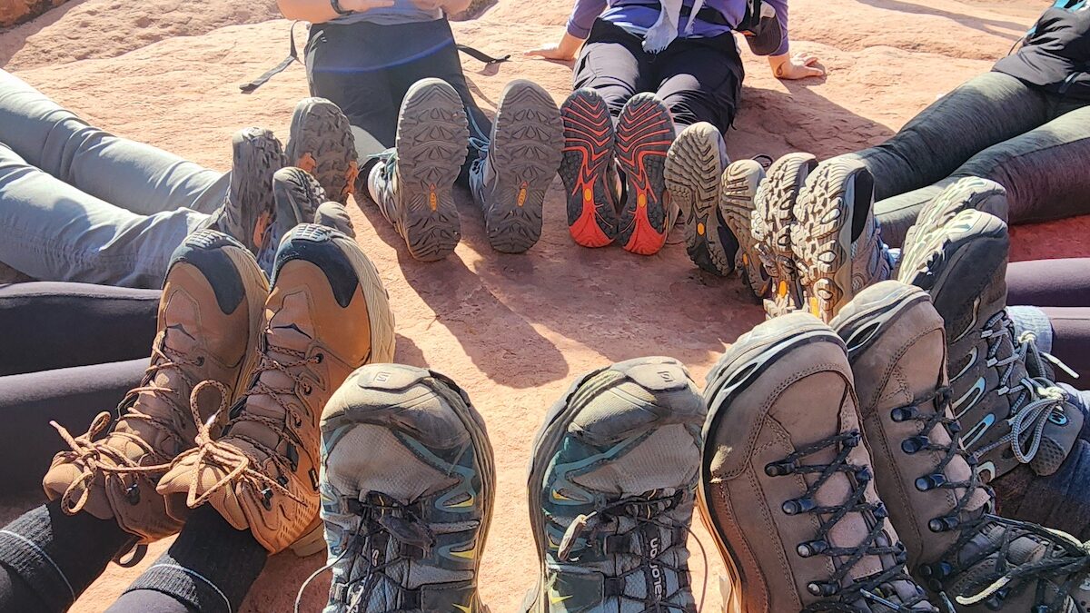 Leadership coaches facilitating a debrief session after an outdoor executive team building experience in Barcelona