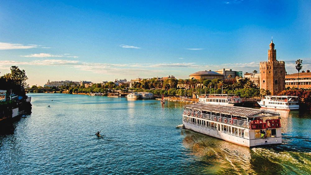 Corporate team experience in Seville: private fGuadalquivir river sailing along Torre del Oro
