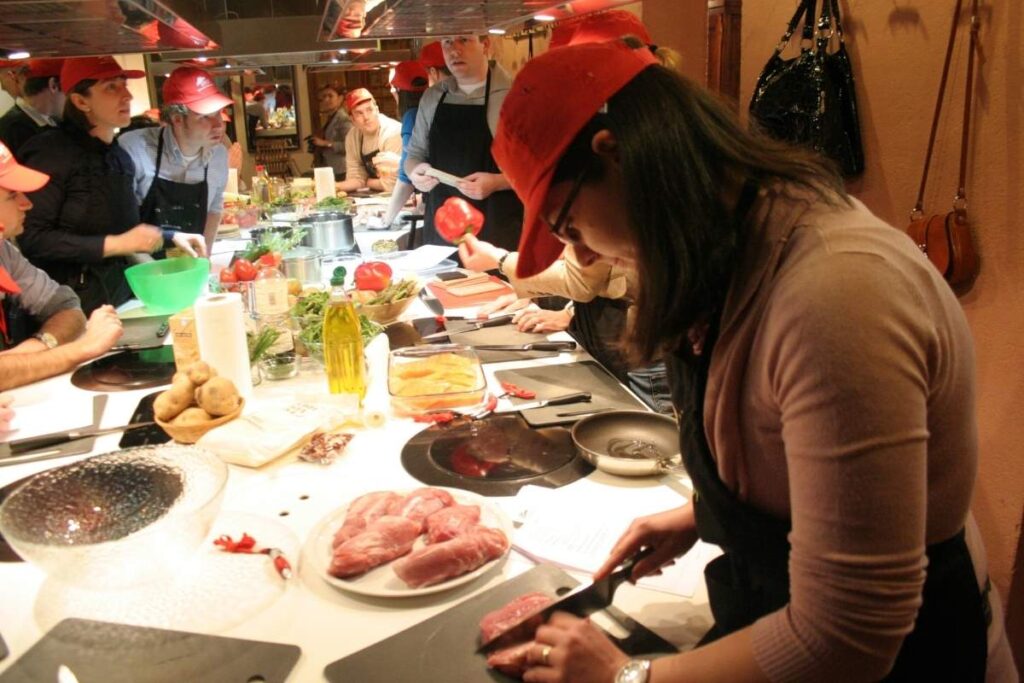Group of corporate colleagues cooking tapas during an incentive trip in Barcelona