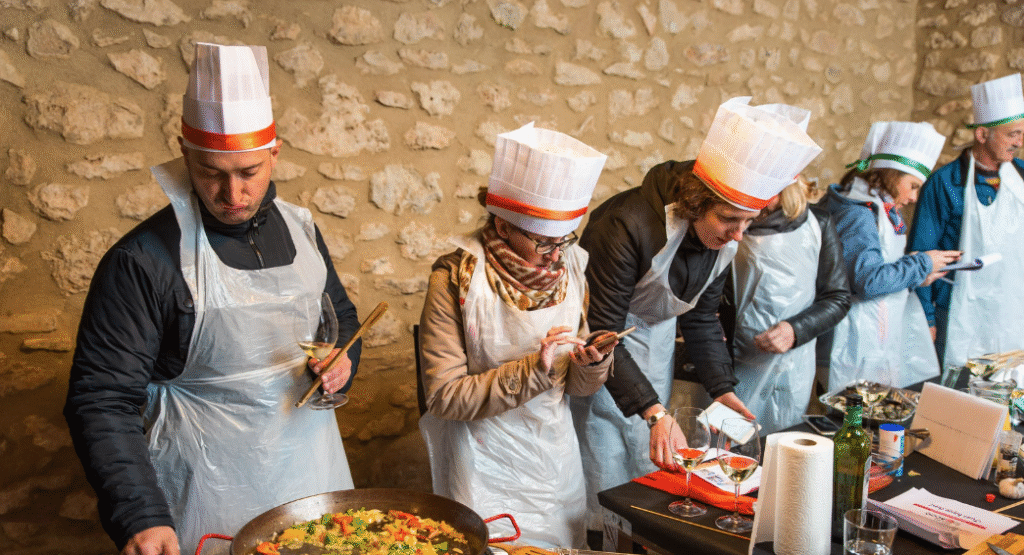 Team cooking traditional paella in a Valencia workshop