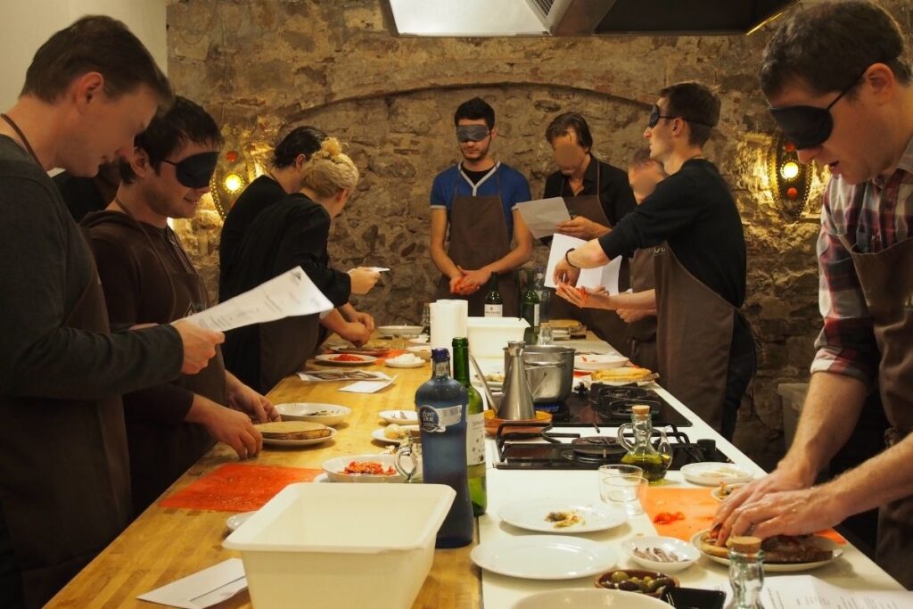 Group taking part in a blindfolded cooking challenge together
